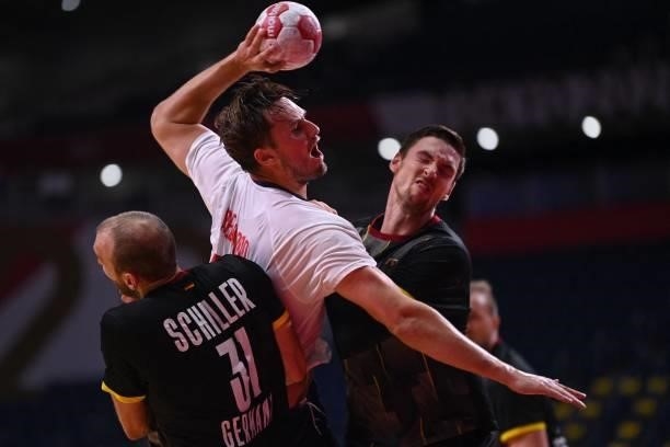 Norway's right back Magnus Abelvik Rod is fouled by Germany's pivot Hendrik Pekeler during the men's preliminary round group A handball match between...