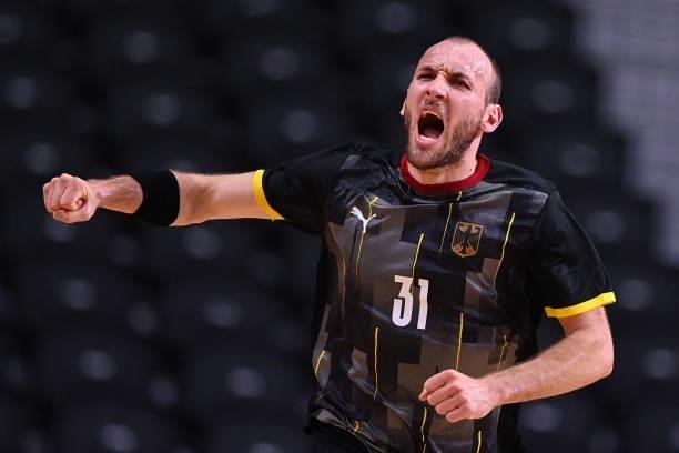 Germany's left wing Marcel Schiller celebrates after scoring during the men's preliminary round group A handball match between Germany and Norway of...