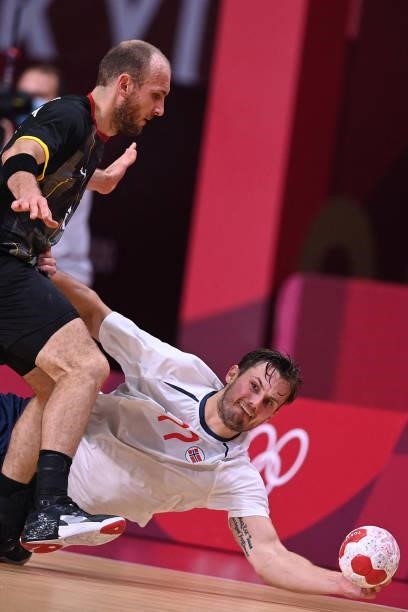 Norway's right back Magnus Abelvik Rod tries to reach the ball past Germany's left wing Marcel Schiller during the men's preliminary round group A...