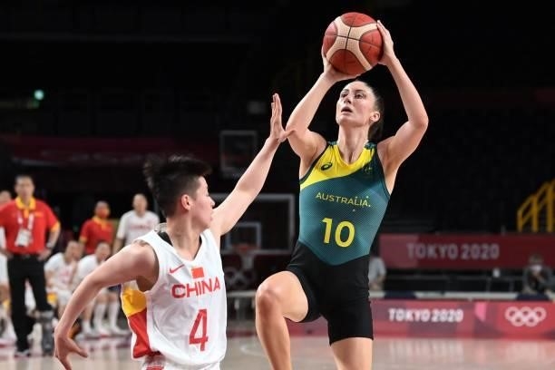 Australia's Katie Ebzery goes to the basket past China's Li Yuan in the women's preliminary round group C basketball match between China and...