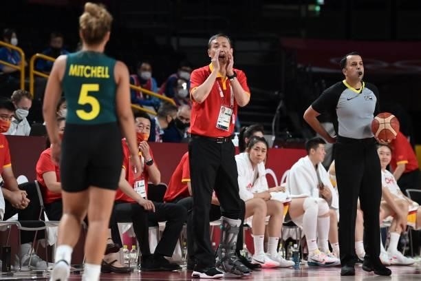 China's team coach Limin Xu speaks to his players on court in the women's preliminary round group C basketball match between China and Australia...
