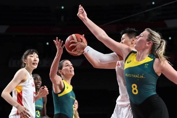 Australia's Liz Cambage fights for the ball with China's Huang Sijing as Australia's Bec Allen and China's Han Xu watch in the women's preliminary...