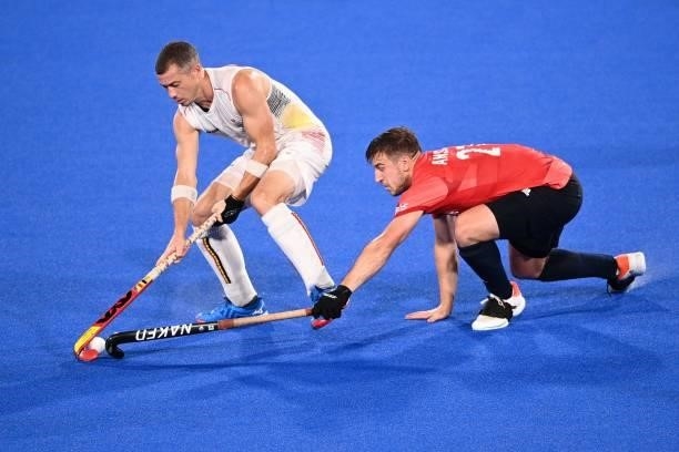 Belgium's John-John Dominique Dohmen is tackled by Britain's Liam Paul Ansell during their men's pool B match of the Tokyo 2020 Olympic Games field...