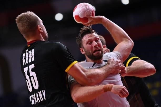 Norway's right back Harald Reinkind shoots during the men's preliminary round group A handball match between Germany and Norway of the Tokyo 2020...