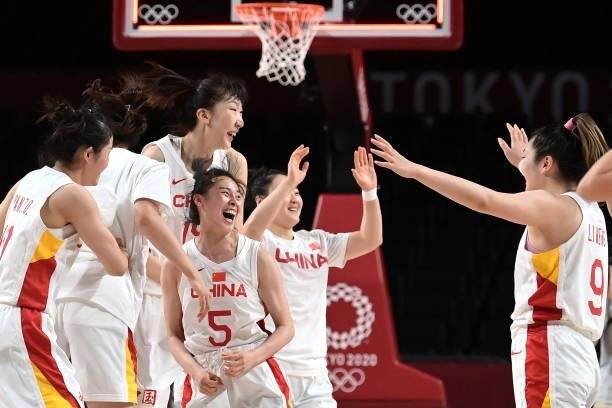 China's players celebrate their win in the women's preliminary round group C basketball match between China and Australia during the Tokyo 2020...