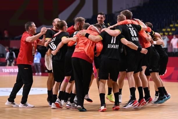 Germany's players celebrate their victory after during the men's preliminary round group A handball match between Germany and Norway of the Tokyo...