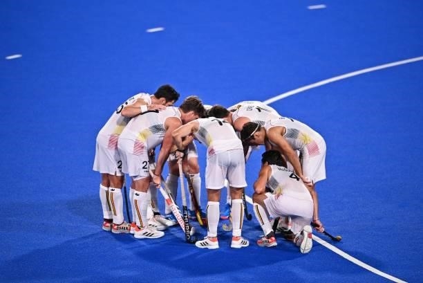 Players of Belgium gather during the men's pool B match of the Tokyo 2020 Olympic Games field hockey competition against Britain, at the Oi Hockey...