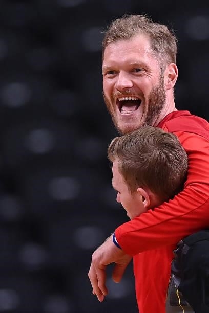 Germany's goalkeeper Johannes Bitter and a teammate celebrate their victory after during the men's preliminary round group A handball match between...