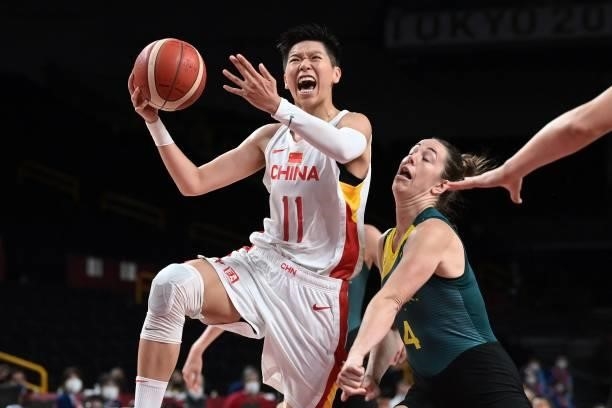 China's Huang Sijing goes to the basket past Australia's Jenna O'hea in the women's preliminary round group C basketball match between China and...