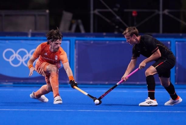 Billy Bakker of Netherlands battle for the ball during the Men's Pool B - Hockey Match between Germany and Netherlands on day seven of the Tokyo 2020...