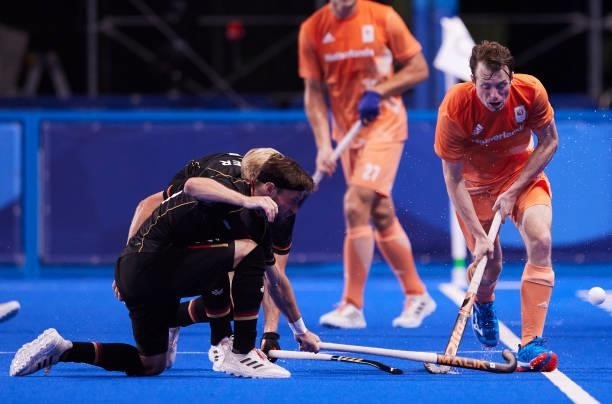 Severiano Boris van Ass of Netherlands battle for the ball during the Men's Pool B - Hockey Match between Germany and Netherlands on day seven of the...