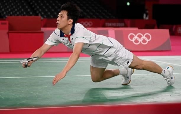 South Korea's Heo Kwang-hee dives for a shot to Guatemala's Kevin Cordon in their men's singles badminton quarter final match during the Tokyo 2020...