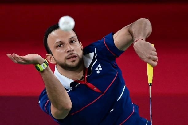 Guatemala's Kevin Cordon hits a shot to South Korea's Heo Kwang-hee in their men's singles badminton quarter final match during the Tokyo 2020...