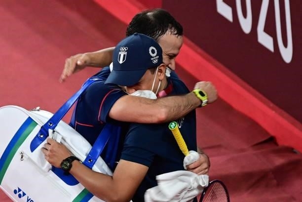 Guatemala's Kevin Cordon celebrates with a coach after beating South Korea's Heo Kwang-hee in their men's singles badminton quarter final match...