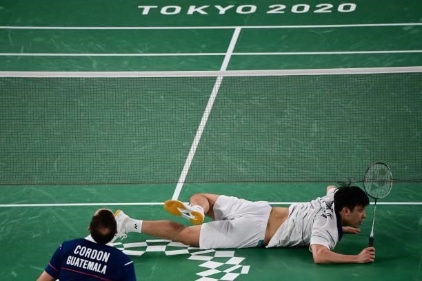 South Korea's Heo Kwang-hee reacts after diving for a shot to Guatemala's Kevin Cordon in their men's singles badminton quarter final match during...
