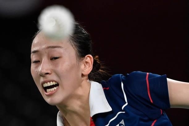 South Korea's Lee So-hee reacts as she hits a shot next to South Korea's Shin Seung-chan in their women's doubles badminton semi-final match against...