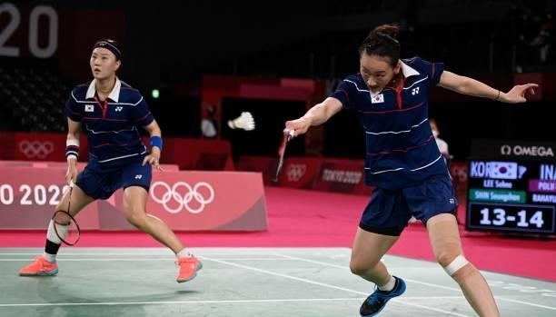South Korea's Lee So-hee hits a shot next to South Korea's Shin Seung-chan in their women's doubles badminton semi-final match against Indonesia's...