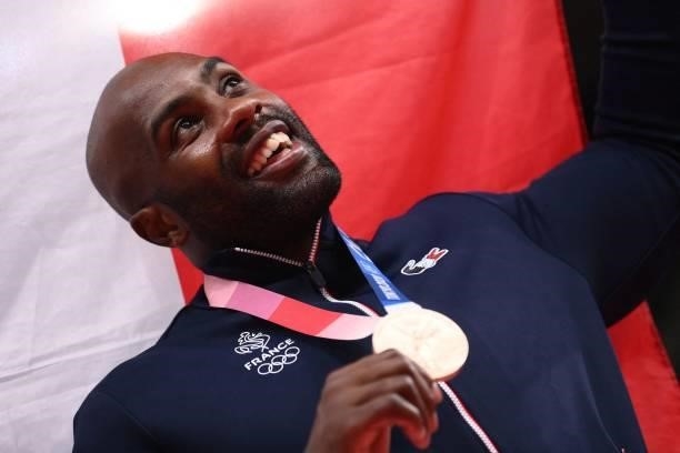 France's Teddy Riner poses with his bronze medal during the podium ceremony for the judo men's +100kg during the Tokyo 2020 Olympic Games at the...