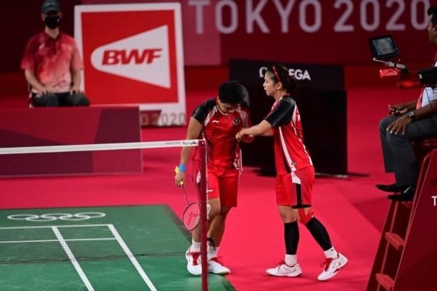 Indonesia's Greysia Polii and Indonesia's Apriyani Rahayu react after a point in their women's doubles badminton semi-final match against South...