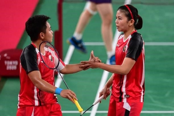 Indonesia's Greysia Polii and Indonesia's Apriyani Rahayu react after a point in their women's doubles badminton semi-final match against South...