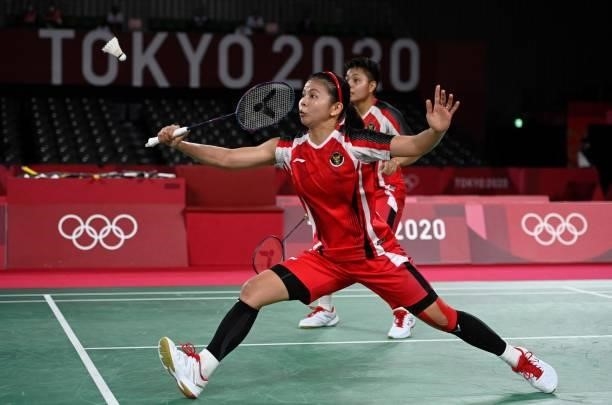 Indonesia's Greysia Polii hits a shot next to Indonesia's Apriyani Rahayu in their women's doubles badminton semi-final match against South Korea's...