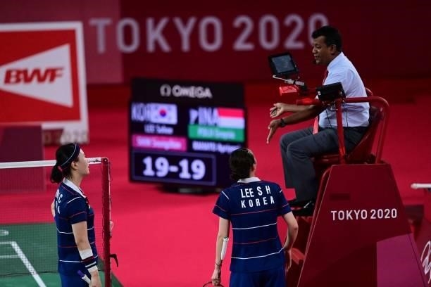 South Korea's Shin Seung-chan and South Korea's Lee So-hee speak to the umpire in their women's doubles badminton semi-final match against...