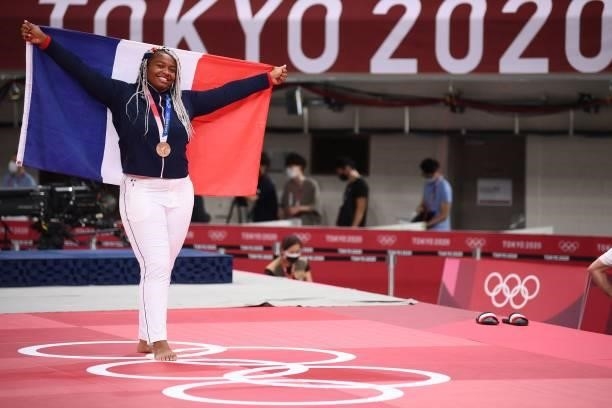 France's Romane Dicko holds the French flag as she poses with her bronze medal during the podium ceremony for judo women's +78kg category during the...