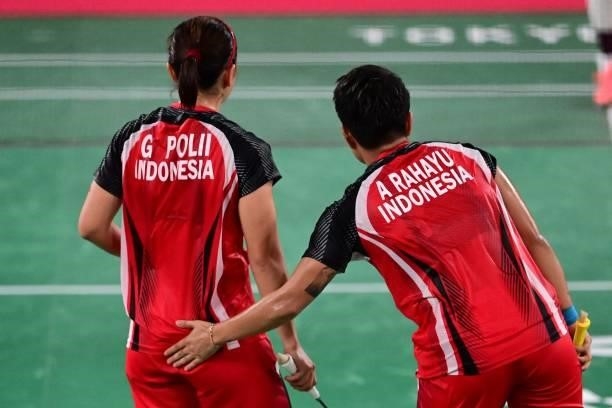 Indonesia's Greysia Polii and Indonesia's Apriyani Rahayu interact between points in their women's doubles badminton semi-final match against South...