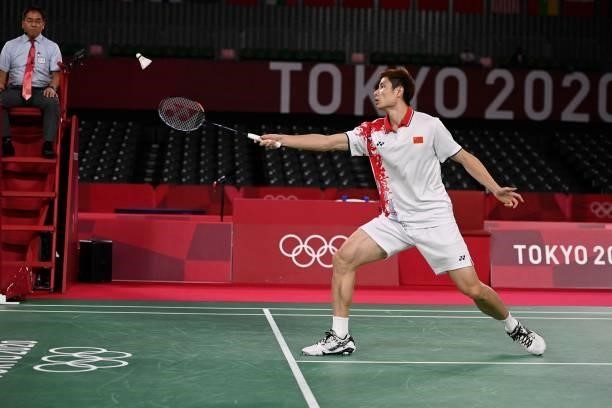 China's Shi Yuqi hits a shot to Denmark's Viktor Axelsen in their men's singles badminton quarter final match during the Tokyo 2020 Olympic Games at...