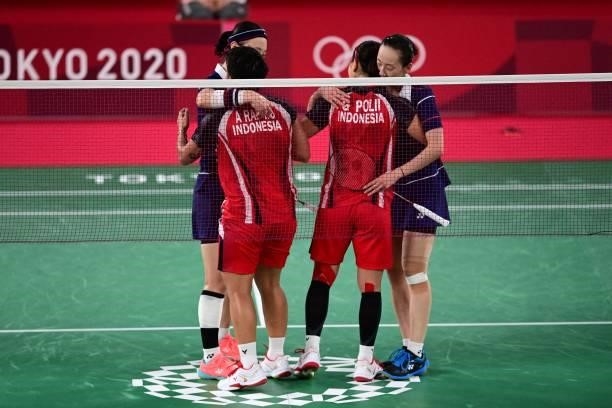 Indonesia's Greysia Polii and Indonesia's Apriyani Rahayu greet South Korea's Shin Seung-chan and South Korea's Lee So-hee after winning their...