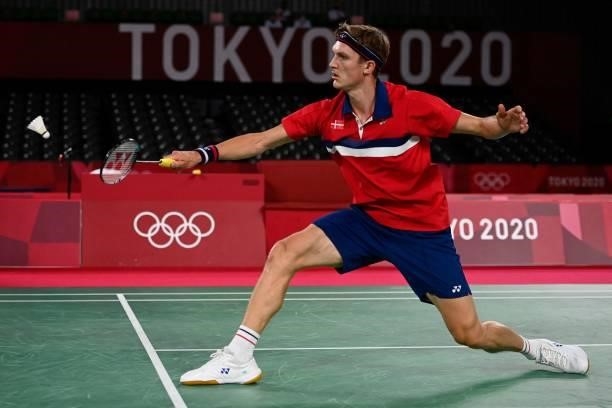 Denmark's Viktor Axelsen hits a shot to China's Shi Yuqi in their men's singles badminton quarter final match during the Tokyo 2020 Olympic Games at...