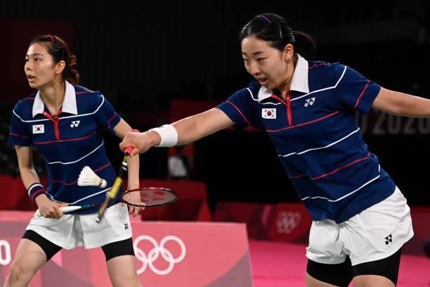 South Korea's Kong Hee-yong hits a shot next to South Korea's Kim So-yeong in their women's doubles badminton semi-final match against China's Chen...