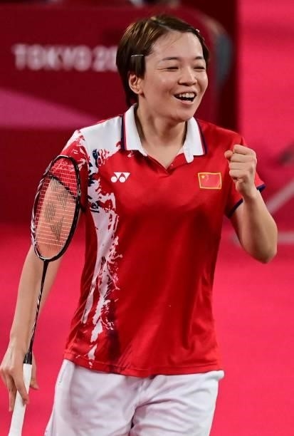 China's Chen Qingchen reacts after a point with China's Jia Yifan in their women's doubles badminton semi-final match against South Korea's Kong...