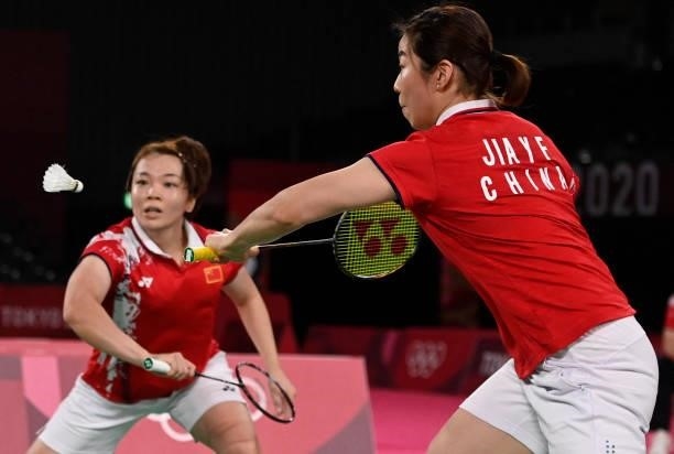 China's Chen Qingchen and China's Jia Yifan reach for a shot in their women's doubles badminton semi-final match against South Korea's Kong Hee-yong...