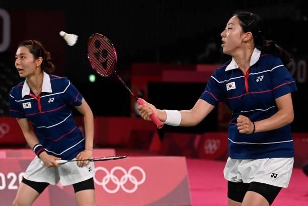 South Korea's Kong Hee-yong hits a shot next to South Korea's Kim So-yeong in their women's doubles badminton semi-final match against China's Chen...
