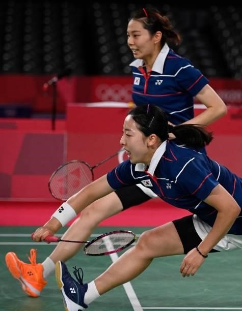 South Korea's Kong Hee-yong and South Korea's Kim So-yeong rush to reach a shot in their women's doubles badminton semi-final match against China's...