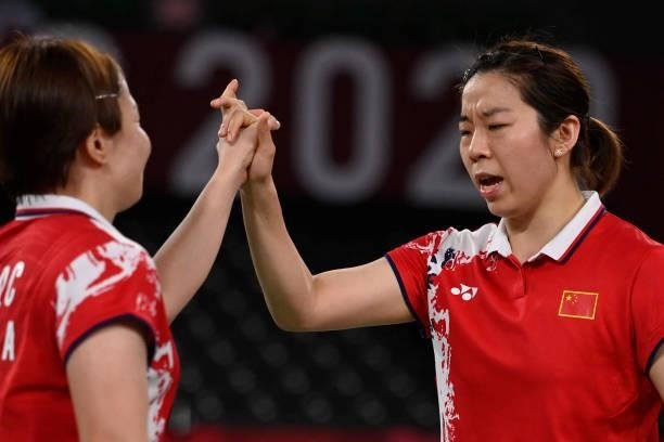 China's Chen Qingchen and China's Jia Yifan celebrate as they win their women's doubles badminton semi-final match against South Korea's Kong...