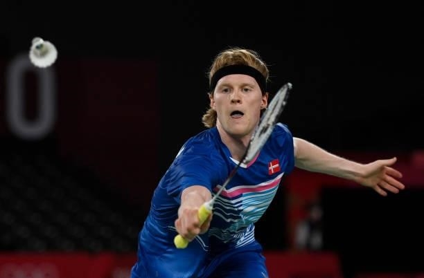 Denmark's Anders Antonsen hits a shot to Indonesia's Anthony Sinisuka Ginting in their men's singles badminton quarter final match during the Tokyo...