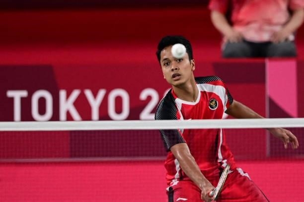 Indonesia's Anthony Sinisuka Ginting hits a shot to Denmark's Anders Antonsen in their men's singles badminton quarter final match during the Tokyo...
