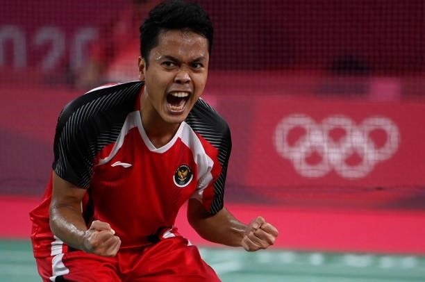 Indonesia's Anthony Sinisuka Ginting celebrates after beating Denmark's Anders Antonsen in their men's singles badminton quarter final match during...