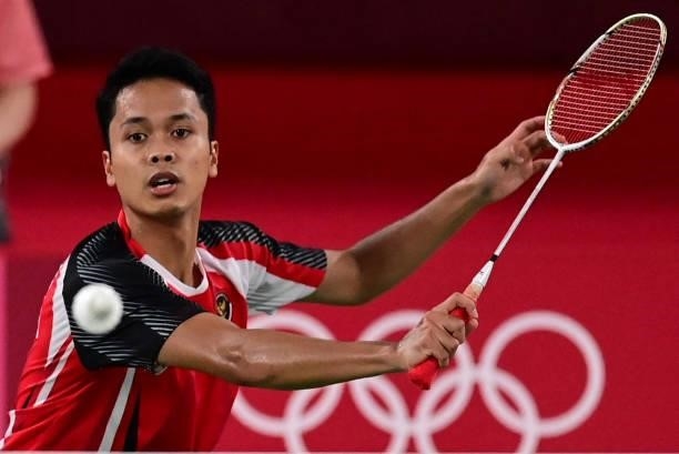 Indonesia's Anthony Sinisuka Ginting hits a shot to Denmark's Anders Antonsen in their men's singles badminton quarter final match during the Tokyo...