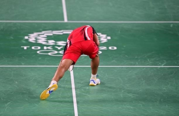 Indonesia's Anthony Sinisuka Ginting reacts after a point with Denmark's Anders Antonsen in their men's singles badminton quarter final match during...