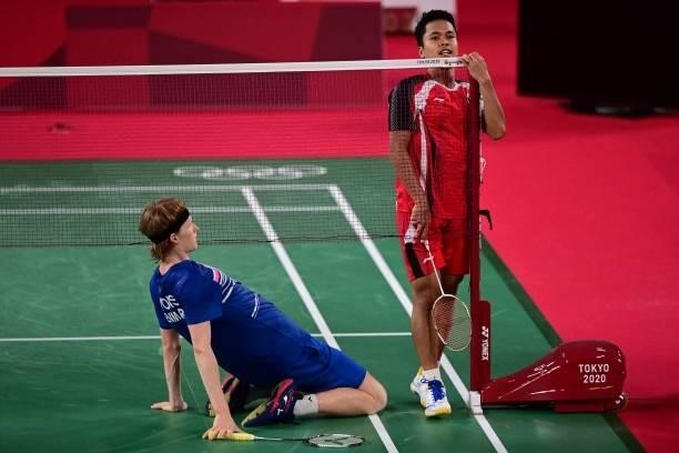 Denmark's Anders Antonsen and Indonesia's Anthony Sinisuka Ginting react after a point in their men's singles badminton quarter final match during...