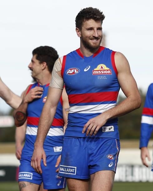 Marcus Bontempelli of the Bulldogs leads the team off the ground after a win during the 2021 AFL Round 20 match between the Western Bulldogs and the...