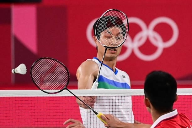Taiwan's Chou Tien-chen reacts during a rally with China's Chen Long in their men's singles badminton quarter final match during the Tokyo 2020...