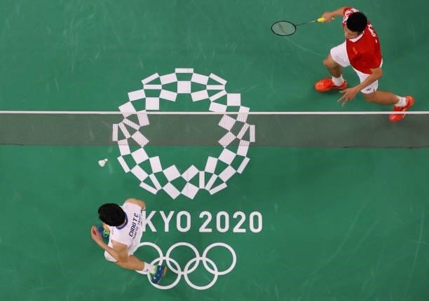 Taiwan's Chou Tien-chen and China's Chen Long react during a point in their men's singles badminton quarter final match during the Tokyo 2020 Olympic...