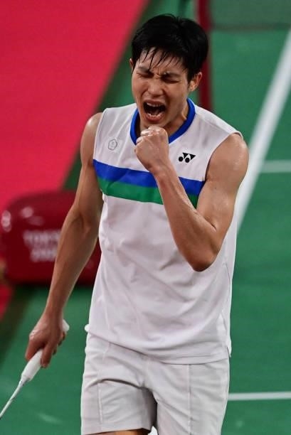 Taiwan's Chou Tien-chen reacts after a point with China's Chen Long in their men's singles badminton quarter final match during the Tokyo 2020...