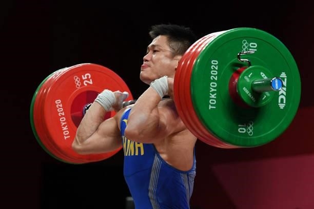 China's Lyu Xiaojun competes in the men's 81kg weightlifting competition during the Tokyo 2020 Olympic Games at the Tokyo International Forum in...