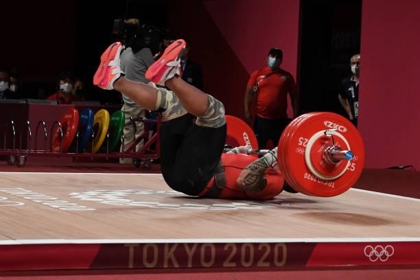 Chile's Arley Mendez Perez falls as he competes in the men's 81kg weightlifting competition during the Tokyo 2020 Olympic Games at the Tokyo...