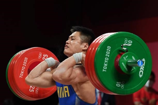 China's Lyu Xiaojun competes in the men's 81kg weightlifting competition during the Tokyo 2020 Olympic Games at the Tokyo International Forum in...